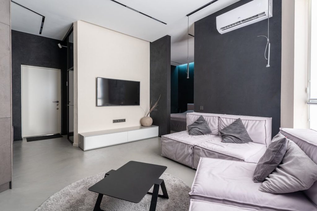 Spacious and stylish modern living room with sleek furnishings and minimalistic decor.